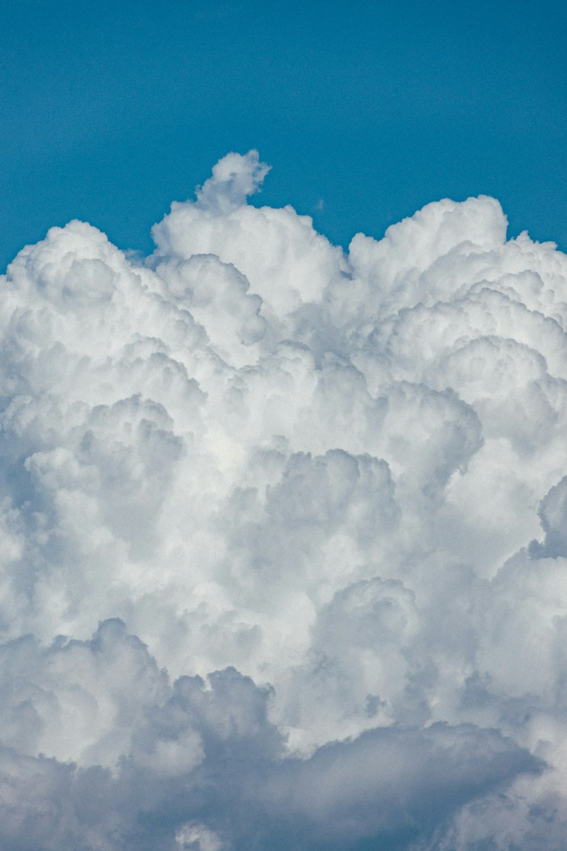 Soft white clouds against a blue afternoon sky